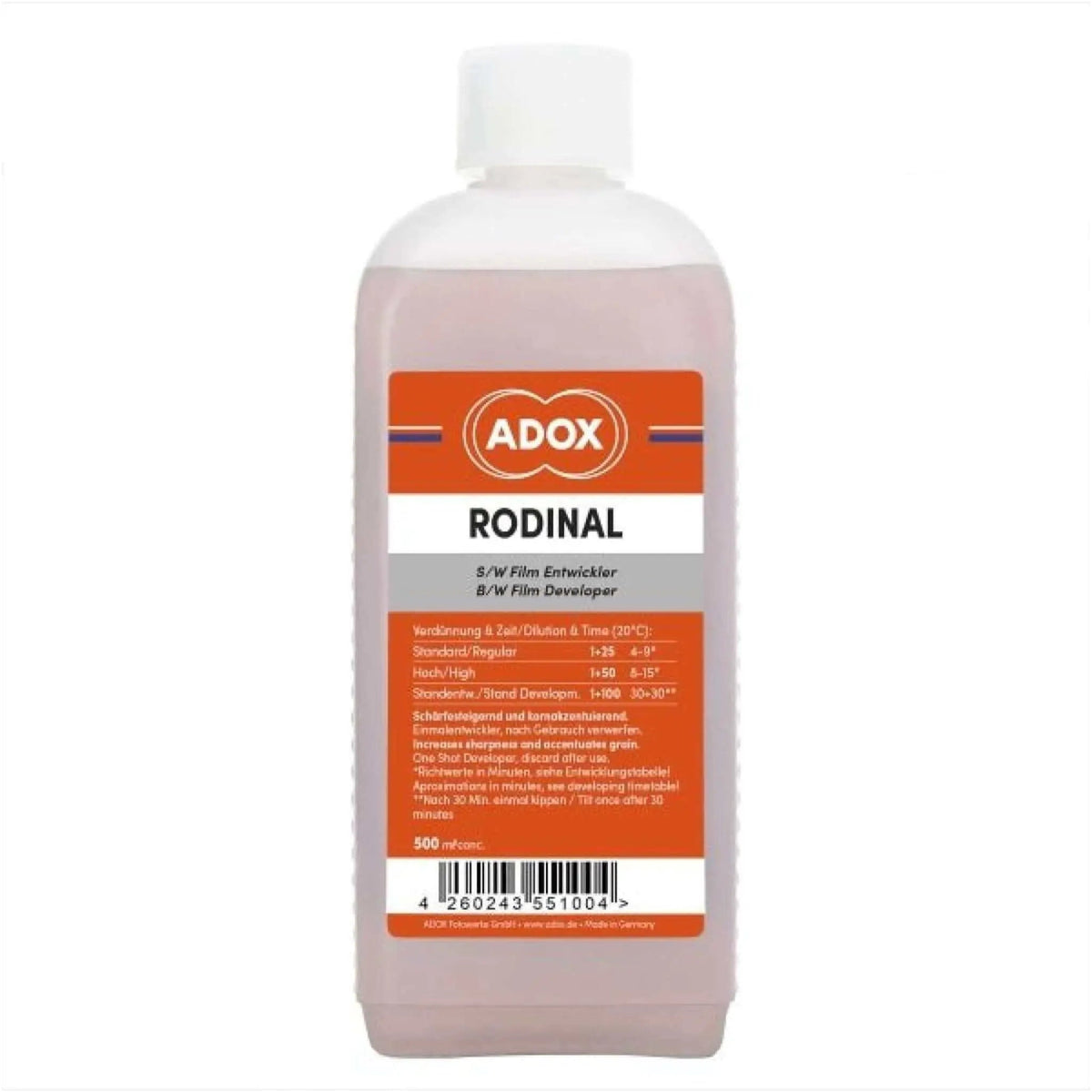 A translucent pink bottle of adox rodinal b/w film developer with a white cap and an orange label featuring black text.