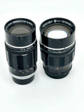 Two black canon camera lenses with silver metallic rings and engraved markings, one labeled 195mm f/3.5 and the other 100mm f/2.
