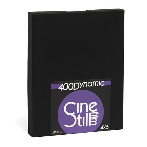 Black rectangular box with a purple and white label featuring the ’400dynamic cinestill’ branding, indicating it contains 25 sheets of 4x5 film.