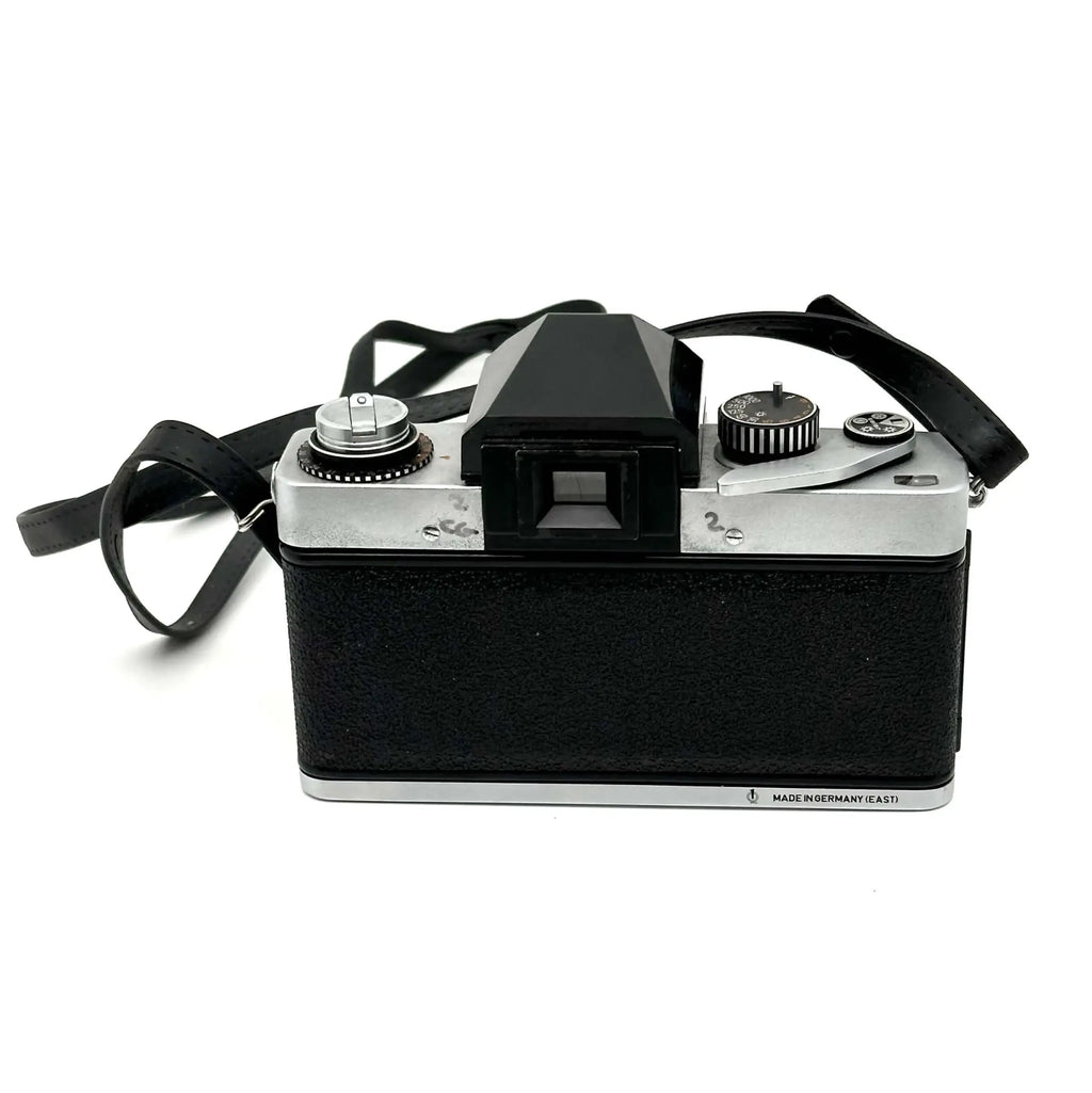 Black and silver vintage film camera with a textured black body, chrome accents, and a viewfinder on top.