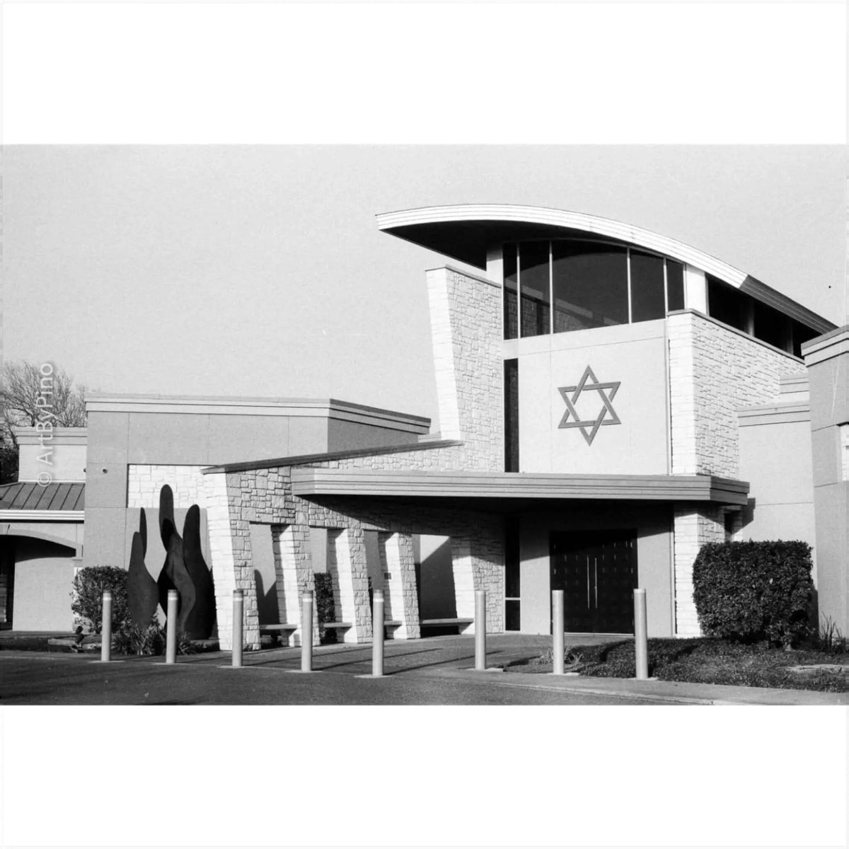 The building features a modern architectural design with stone cladding and a prominent star of david emblem on its facade.