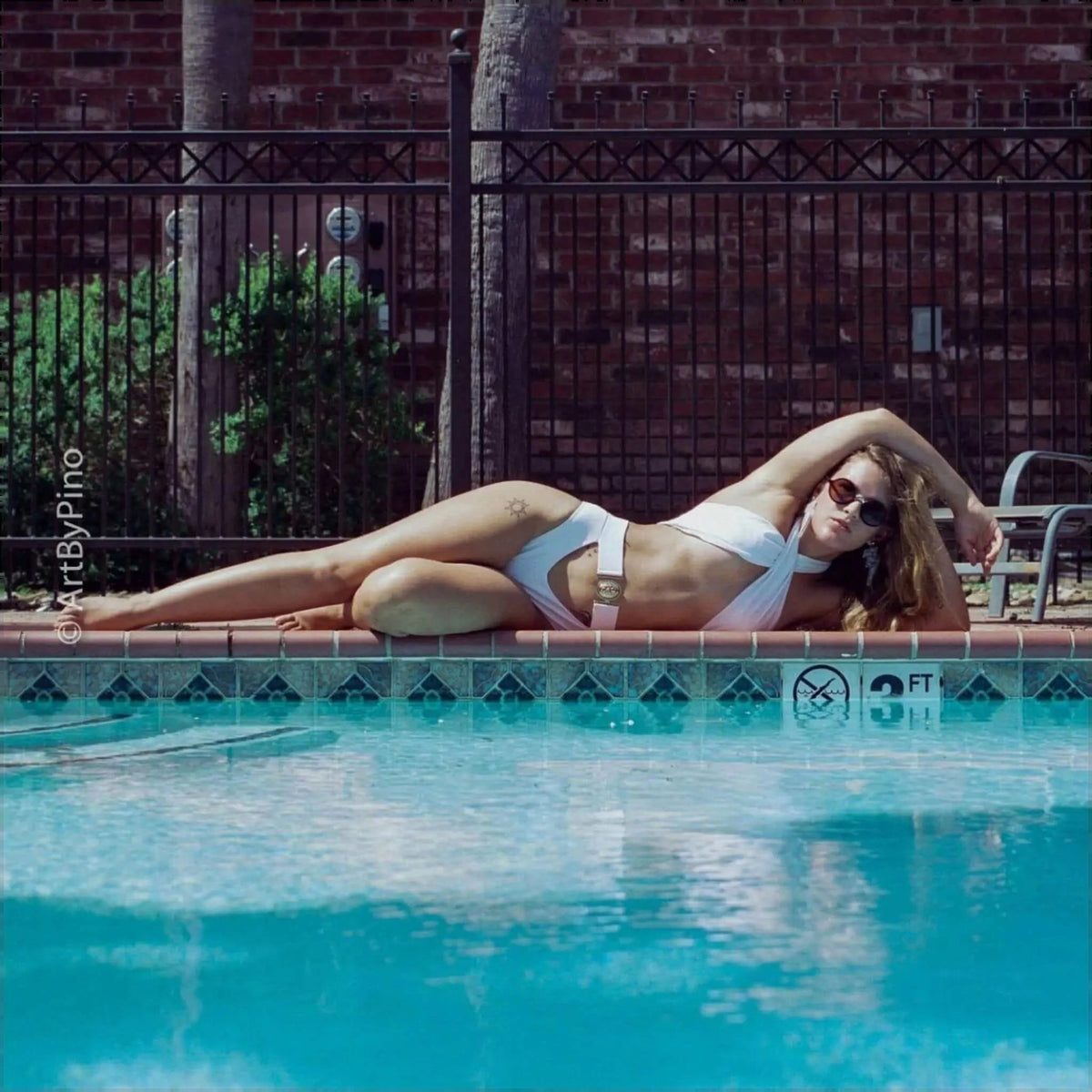 White two-piece bikini with a wide, metallic belt detail at the waist.