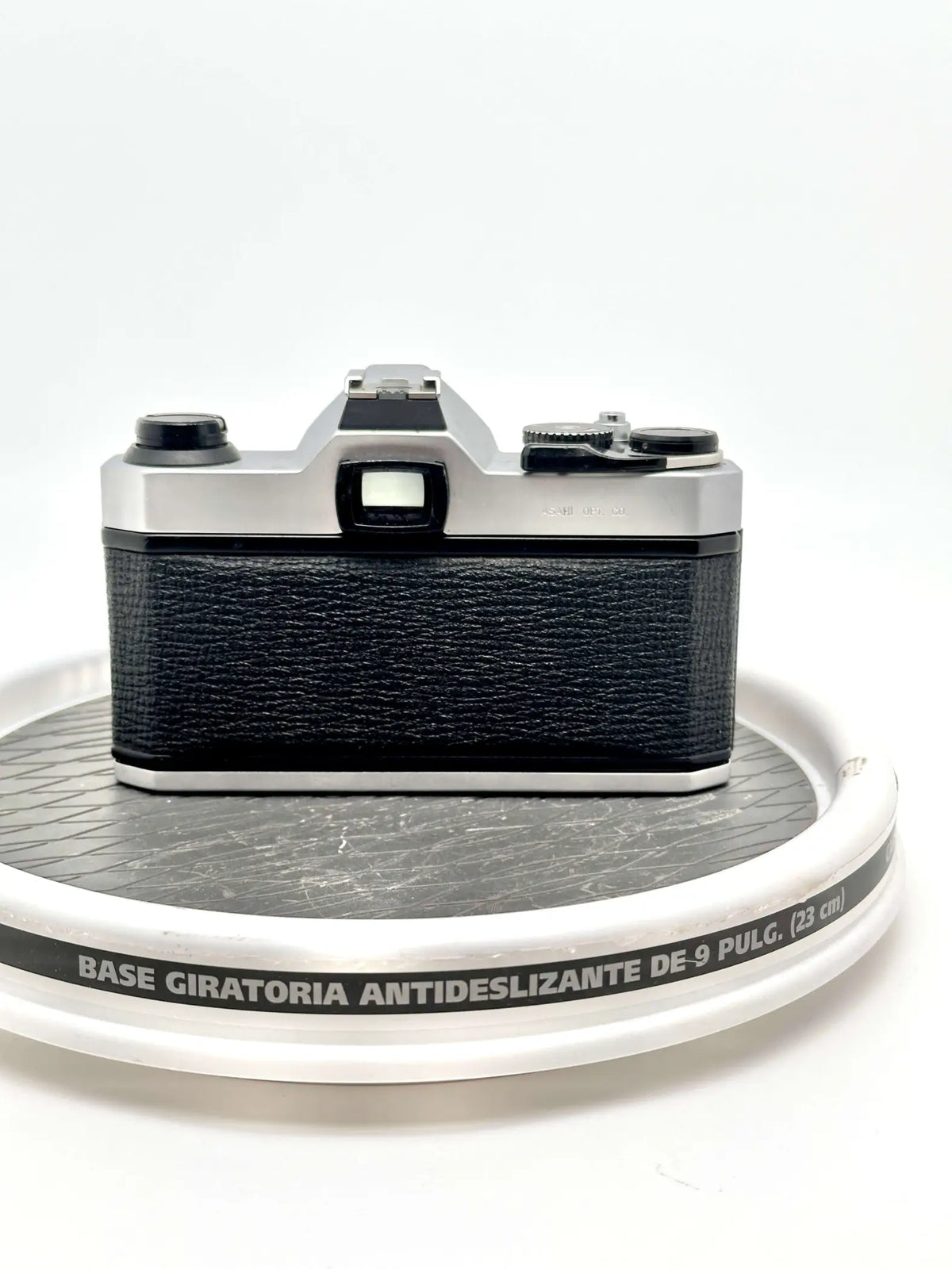 Silver and black canon ae-1 film camera with textured leather grip.
