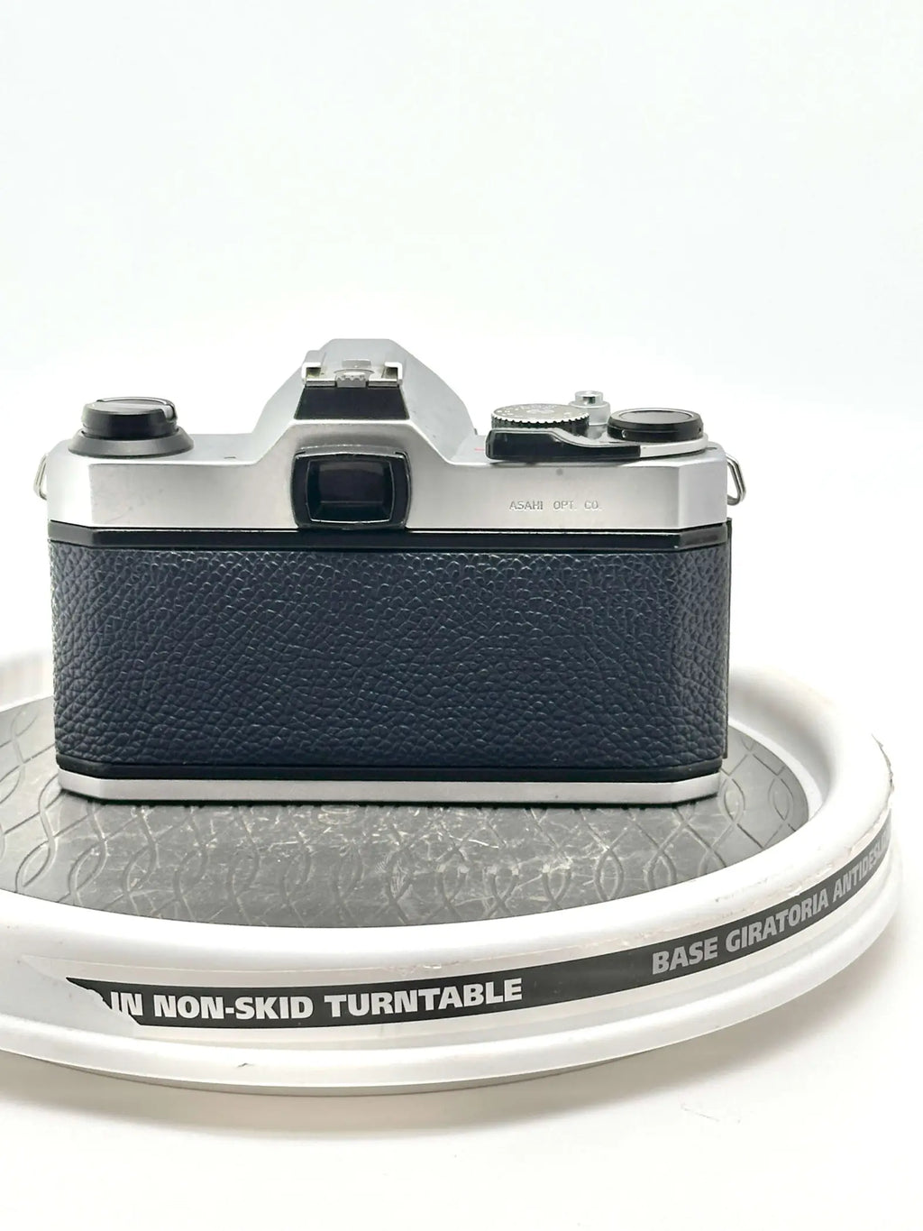 Silver and black vintage camera with textured leather grip.