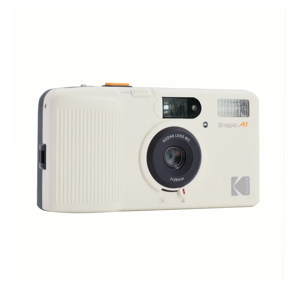 Cream-colored kodak snapie a1 instant camera with a black lens and orange accents.