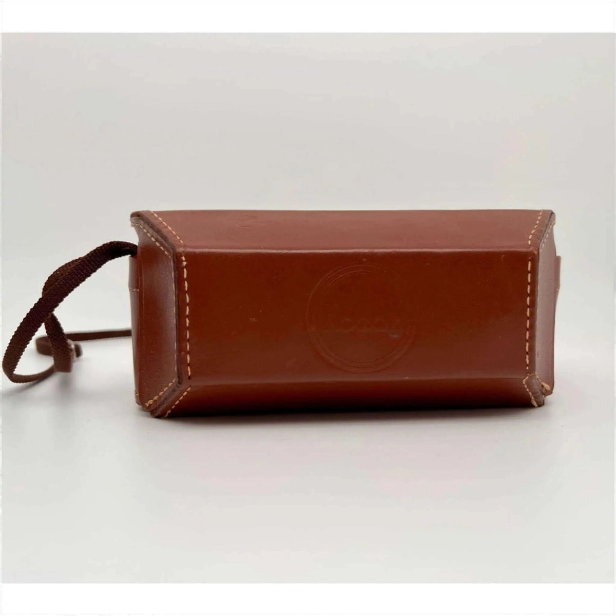 Brown leather camera case with a matching fabric strap and light-colored stitching.