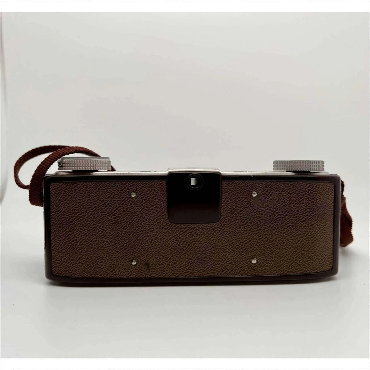 Brown textured leather-bodied vintage camera with silver metal dials and a matching brown strap.
