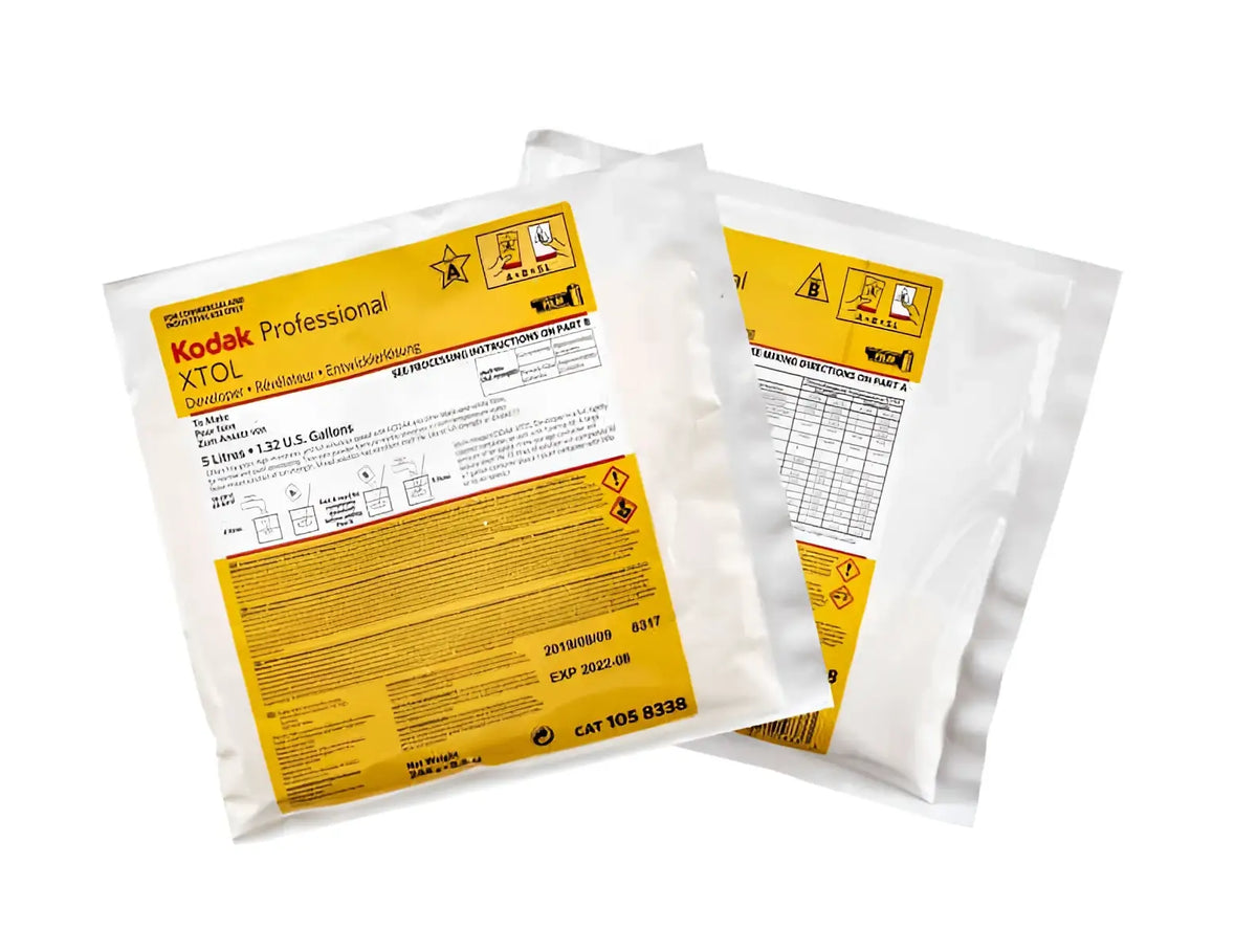 Kodak professional xtol developer packets in white plastic packaging with prominent yellow labeling.