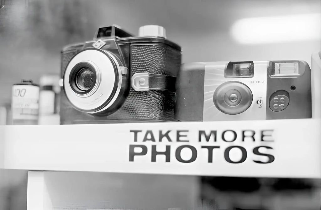 Vintage black-and-white camera with textured leather body and chrome accents.