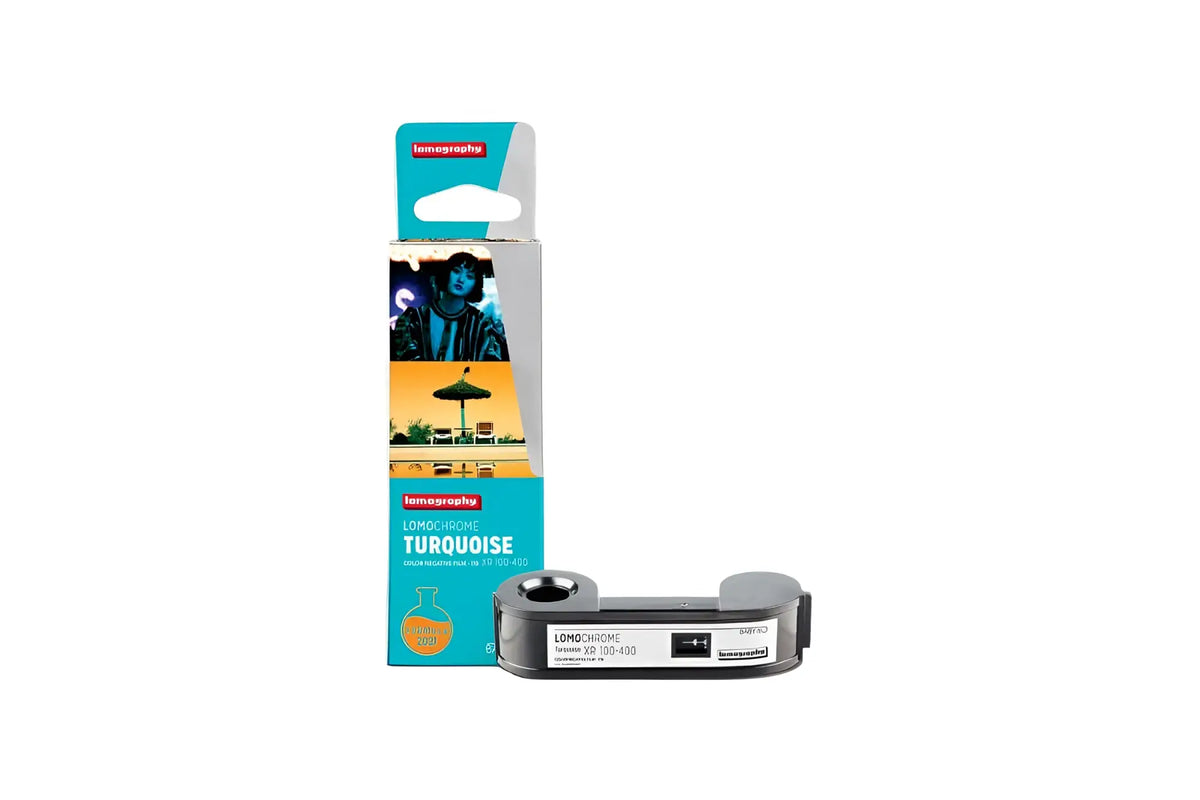 The lomography long chrome turquoise film cartridge, featuring a sleek metallic gray body with black accents and turquoise branding on its packaging.