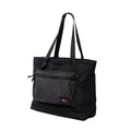 Black tote bag with a grid-patterned front pocket and adjustable shoulder strap.