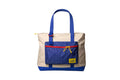 Beige and blue canvas tote bag with a grid-patterned front pocket, red zipper trim, yellow drawstrings, and matching blue handles.