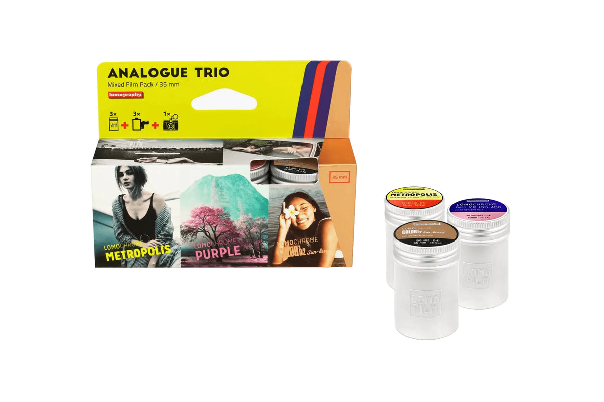 Lomo film pack in a vibrant yellow and orange box with three distinct 35mm film types: metropolis, purple, and noir.