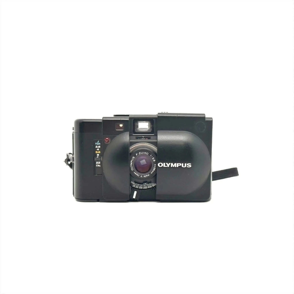 Black olympus camera with a prominent lens and flash.