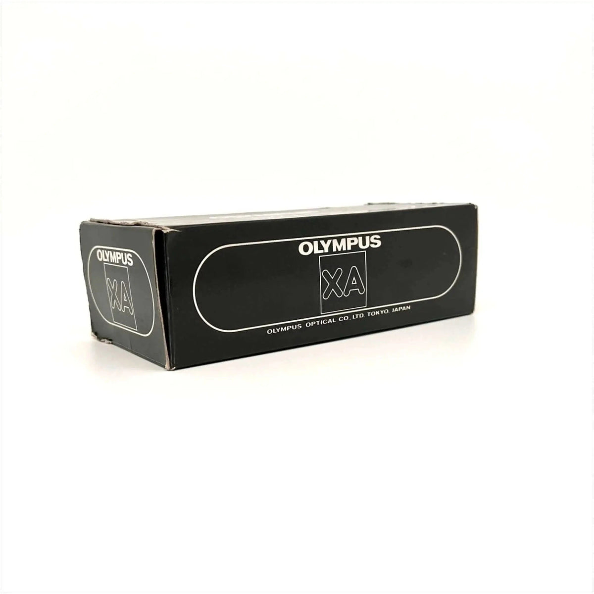 Black rectangular box with white ’olympus xa’ branding and text indicating olympus optical co.