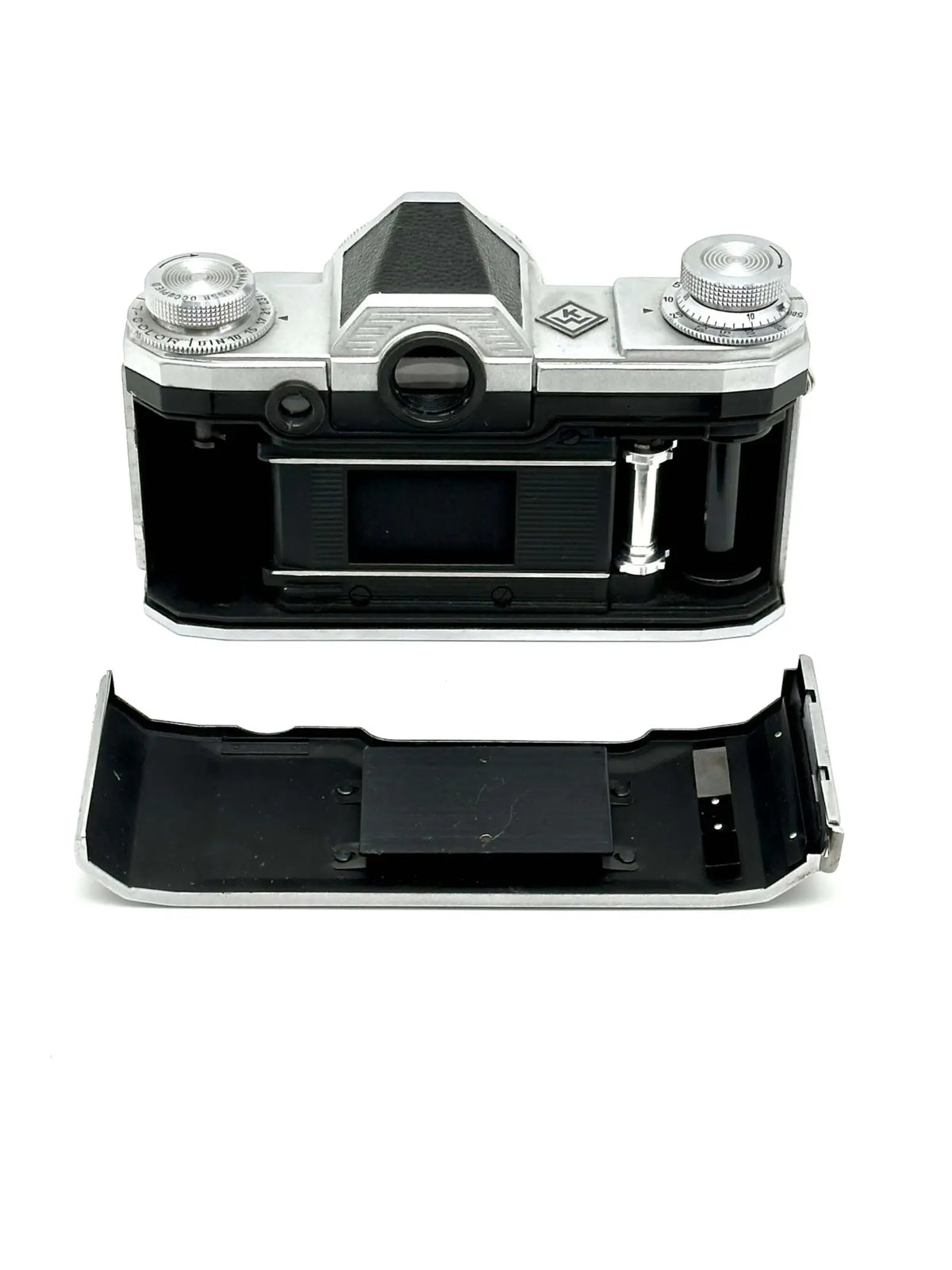 Silver and black kodak retina 35 film camera body with exposed internal components.