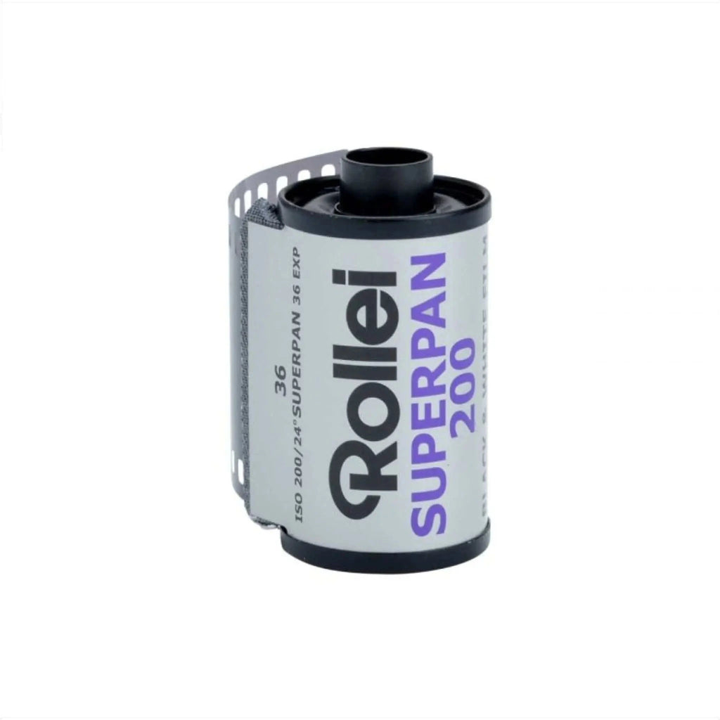 A roll of rollei superpan 200 film, featuring a white label with black and purple text on a cylindrical spool.