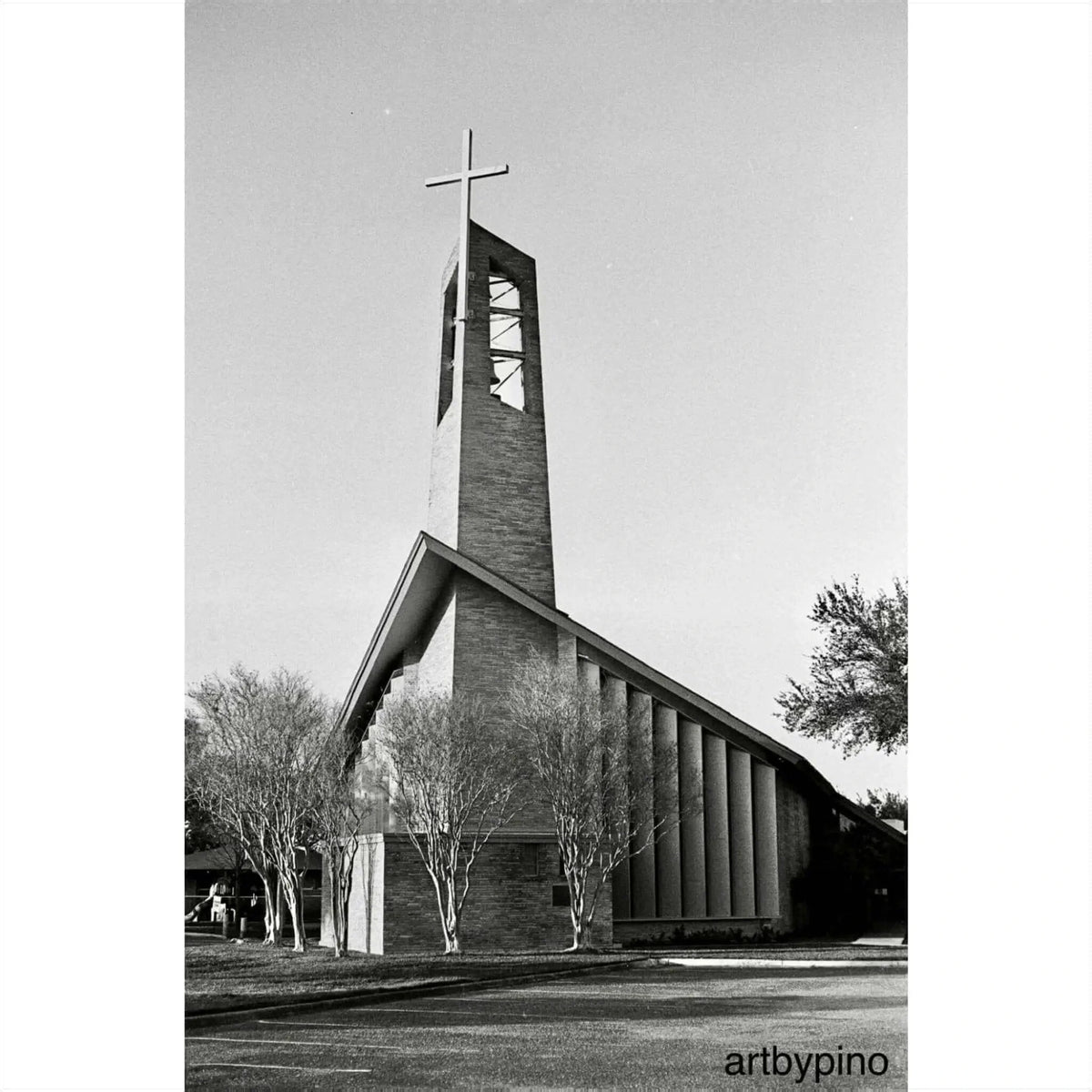 Modern brick church with a tall, angular bell tower topped by a cross.